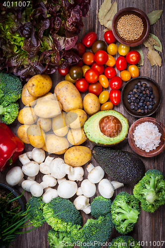 Image of Assorted raw vegetables on wooden background