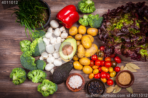 Image of Assorted raw vegetables on wooden background