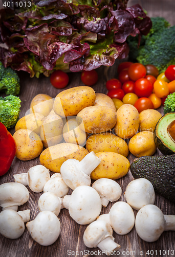 Image of Assorted raw vegetables on wooden background