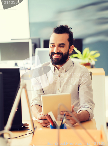Image of happy creative male office worker with tablet pc