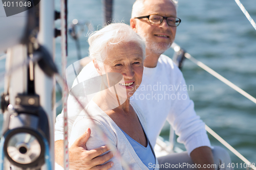 Image of senior couple hugging on sail boat or yacht in sea