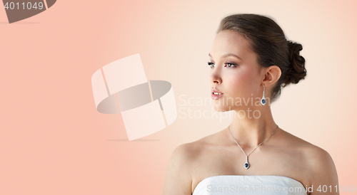 Image of beautiful asian woman with earring and pendant