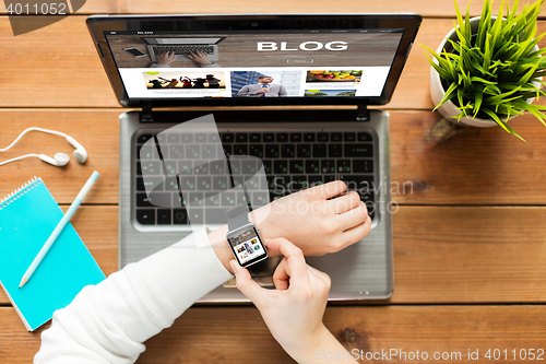 Image of close up of woman with smart watch and laptop