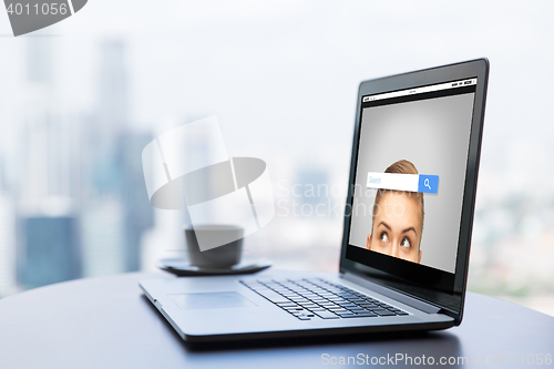 Image of close up of laptop and coffee cup on office table