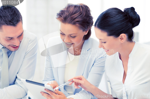 Image of business team working with tablet pcs in office