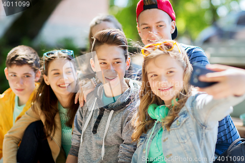 Image of happy teenage students taking selfie by smartphone