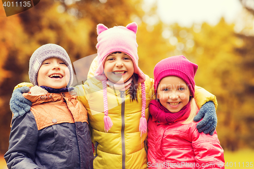 Image of group of happy children hugging in autumn park