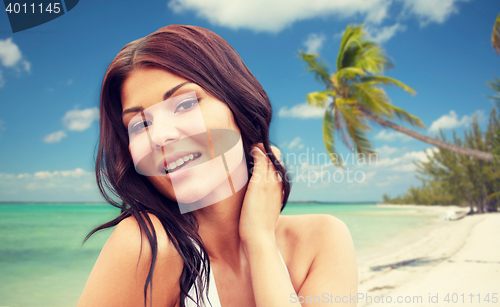 Image of happy young woman on beach