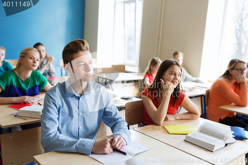 Image of group of students with notebooks at school lesson