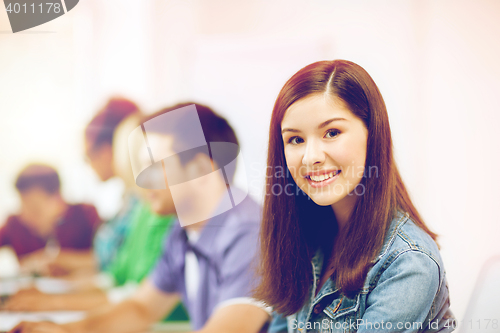 Image of student with computer studying at school