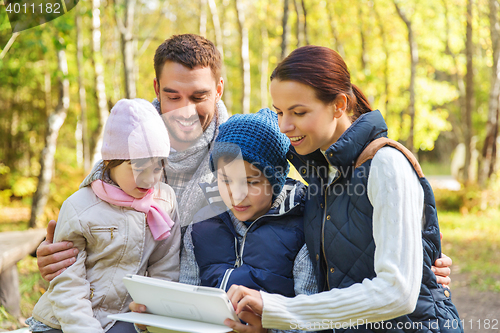 Image of happy family with tablet pc at camp