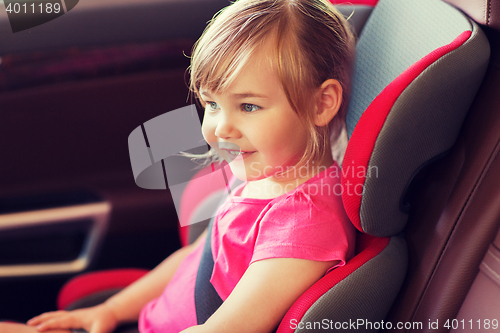 Image of happy little girl sitting in baby car seat