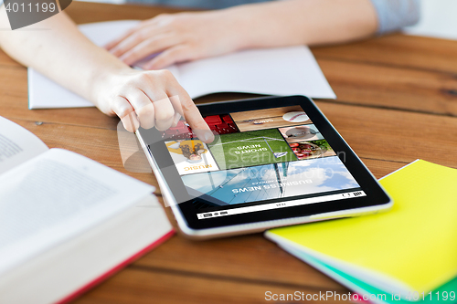 Image of close up of student with tablet pc and notebook