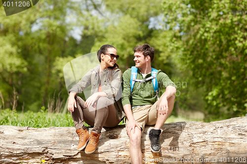 Image of smiling couple with backpacks in nature