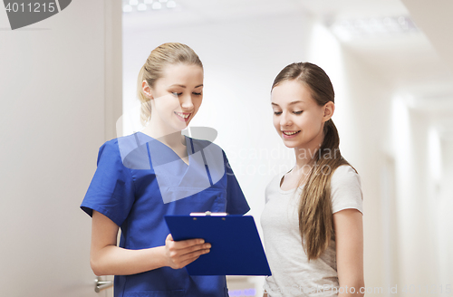 Image of doctor or nurse with clipboard and girl patient