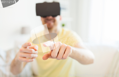 Image of young man in virtual reality headset or 3d glasses