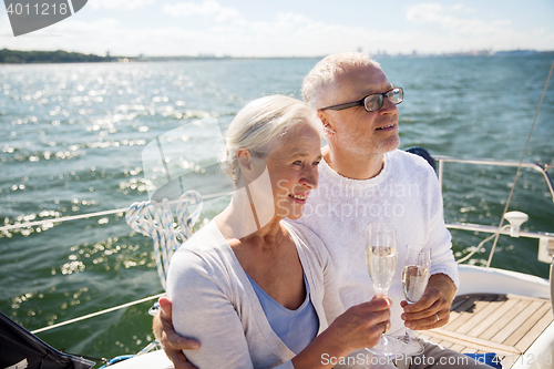 Image of senior couple drinking champagne on sail boat