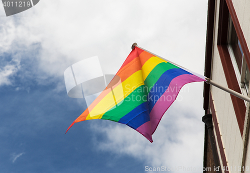 Image of close up of rainbow gay pride flag waving outdoors