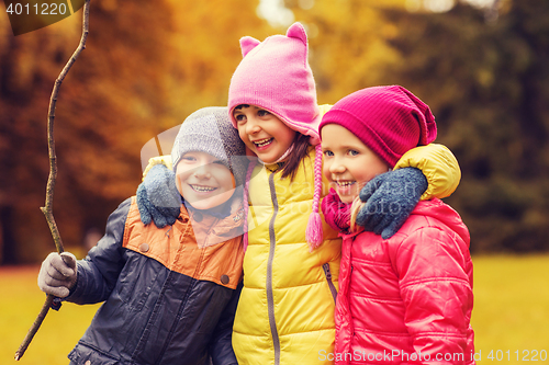 Image of group of happy children hugging in autumn park