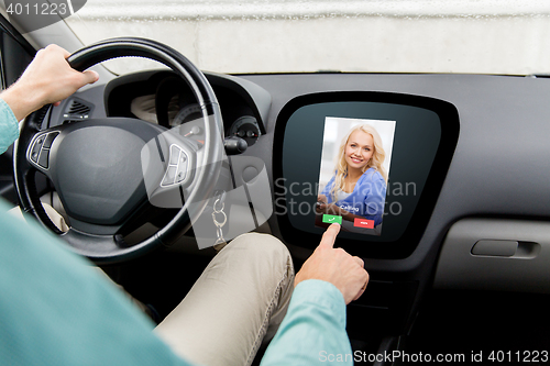 Image of close up of man driving car and receiving call