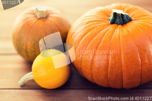 Image of close up of pumpkins on wooden table at home