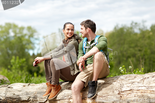 Image of smiling couple with backpacks in nature