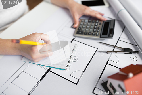 Image of close up of architect hand counting on calculator