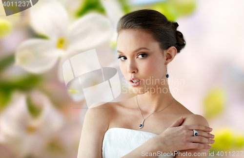 Image of beautiful woman with earring, ring and pendant