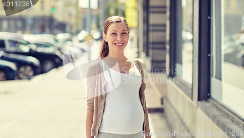 Image of happy smiling pregnant woman at city street