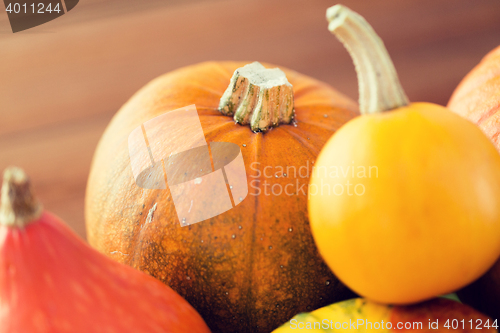 Image of close up of pumpkins on wooden table at home