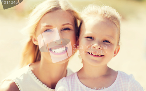 Image of happy mother and little daughter on summer beach