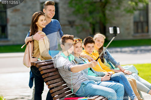 Image of happy teenage students taking selfie by smartphone