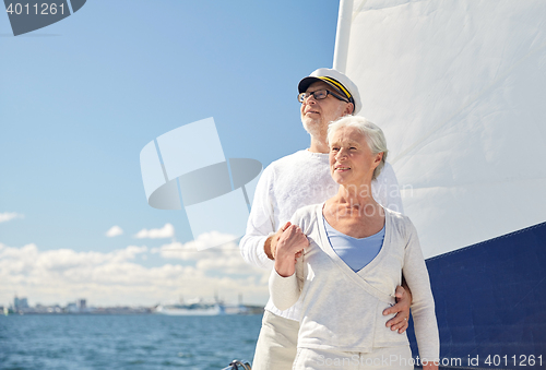 Image of senior couple hugging on sail boat or yacht in sea