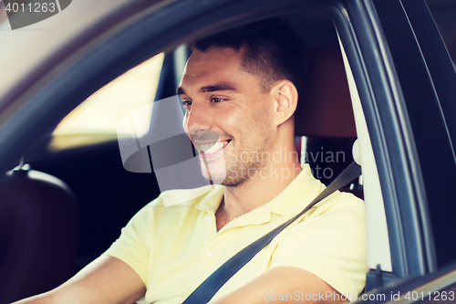 Image of happy smiling man driving car outdoors