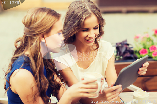 Image of young women with tablet pc and coffee at cafe