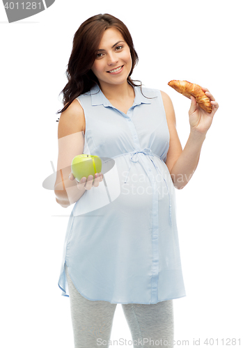 Image of happy pregnant woman with apple and croissant