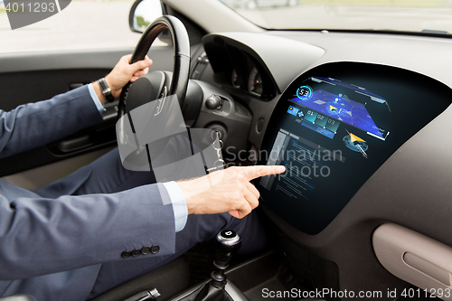 Image of close up of man driving car with navigation system