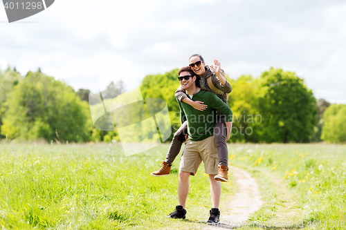 Image of happy couple with backpacks having fun outdoors