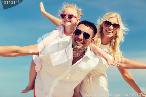 Image of happy family having fun over blue sky background