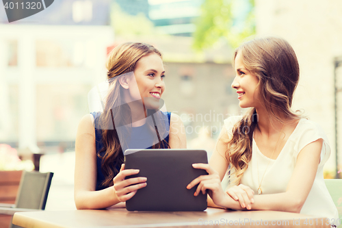Image of happy young women or teenage girls with tablet pc