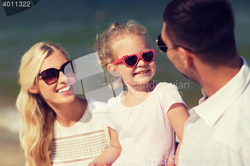 Image of happy family in sunglasses on summer beach