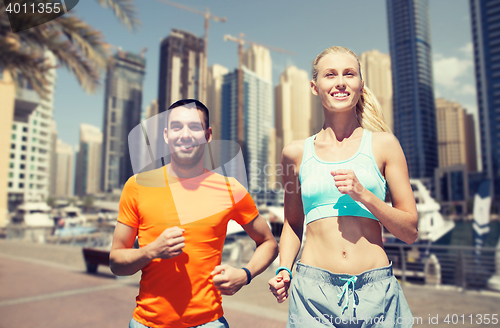 Image of couple running over dubai city street background