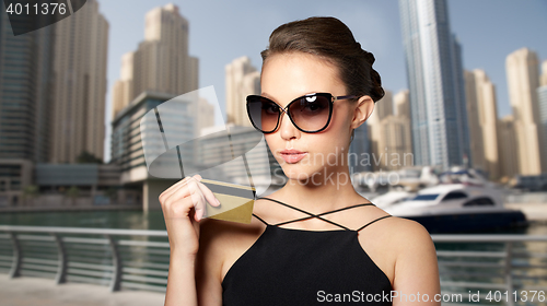 Image of beautiful young woman in elegant black sunglasses