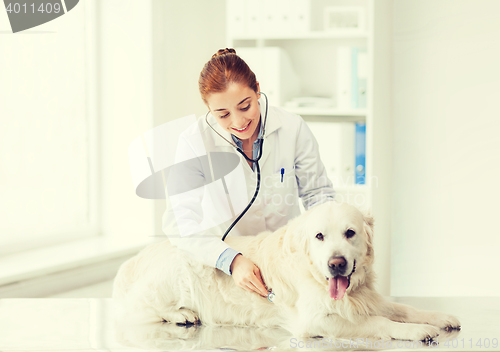 Image of happy woman with dog and doctor at vet clinic