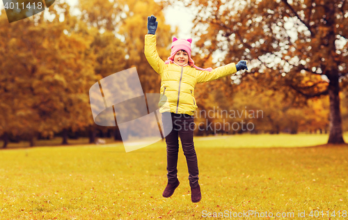 Image of happy little girl jumping outdoors