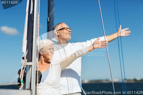 Image of senior couple hugging on sail boat or yacht in sea