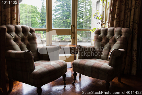 Image of close up of vintage armchairs and table in hotel