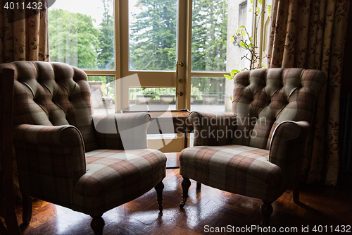 Image of close up of vintage armchairs and table in hotel