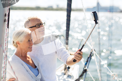 Image of senior couple taking selfie on sail boat or yacht