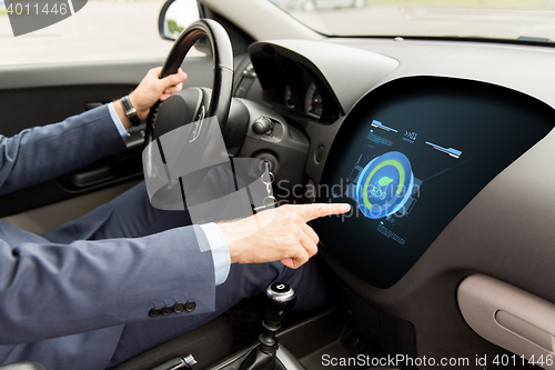 Image of man driving car with eco mode on board computer